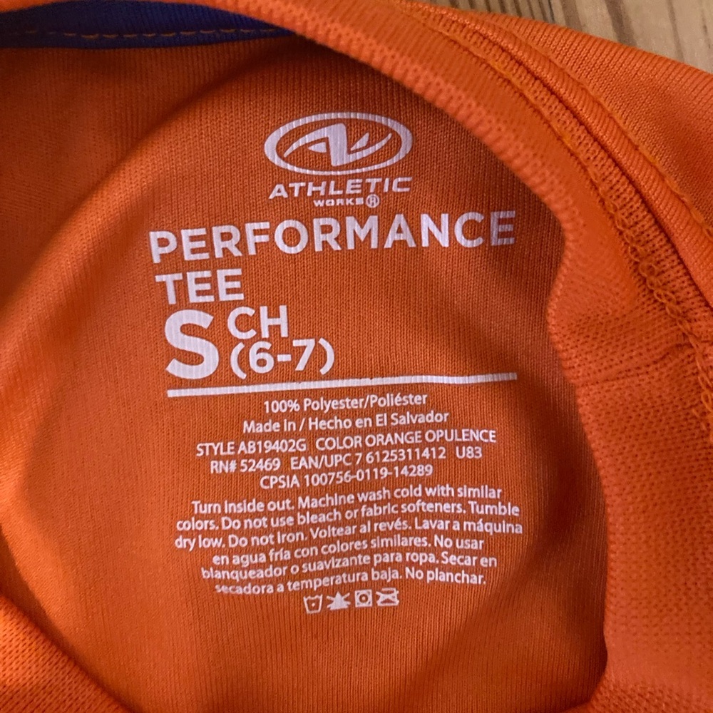 Boys athletic orange sports shirt.